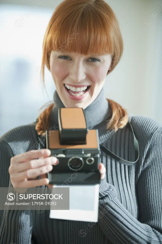 Woman holding vintage camera
