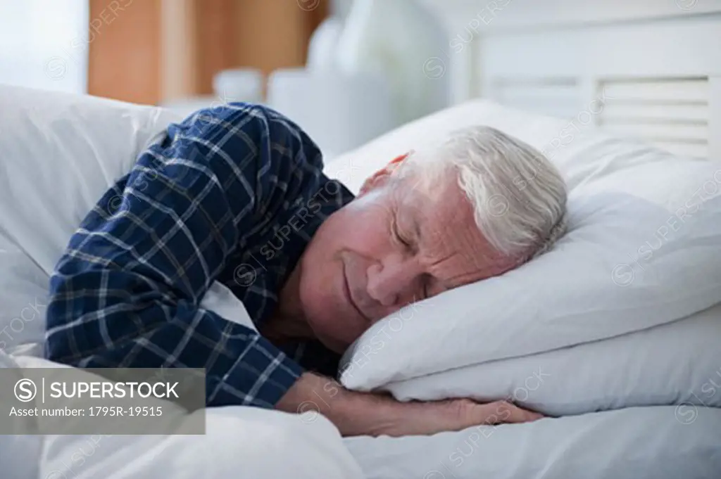 Senior man sleeping in bed