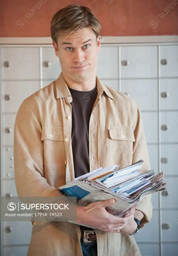 Man holding stack of mail