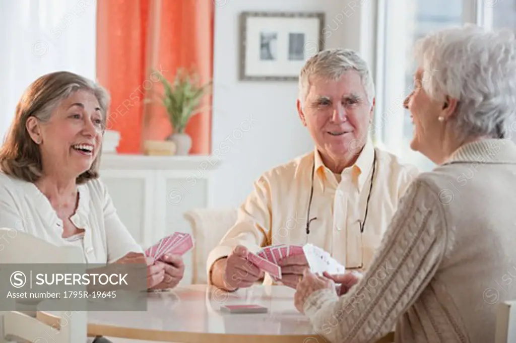 Senior adults playing cards