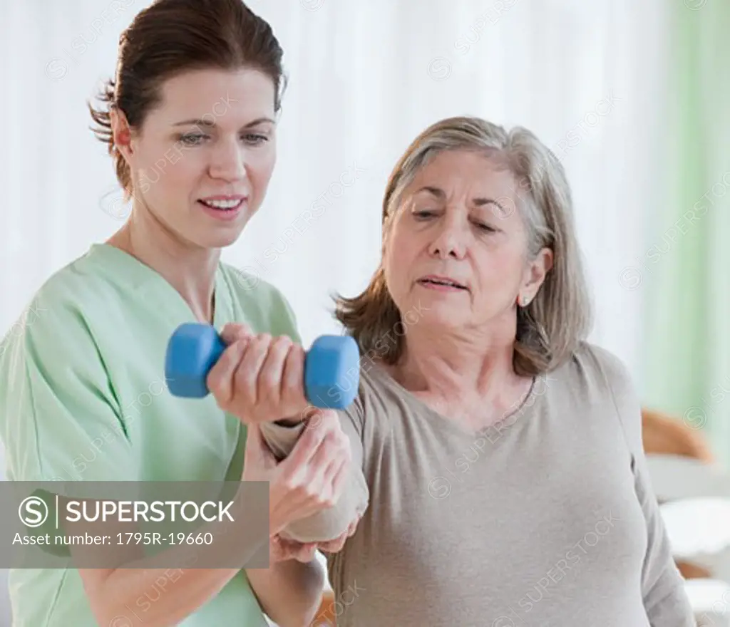 Physical therapist helping senior woman