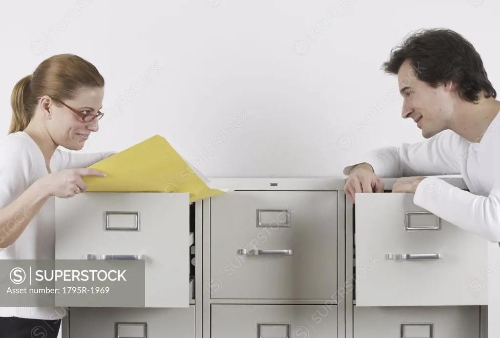 Couple gazing lovingly over file cabinets