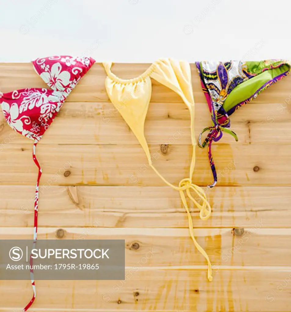 Bikinis drying on fence