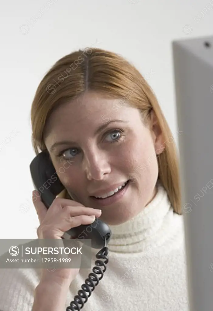 Woman on telephone with computer