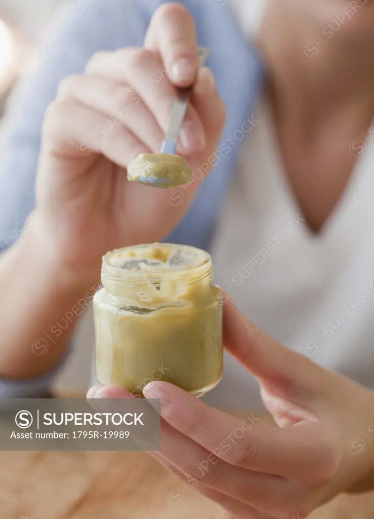 Woman scooping baby food