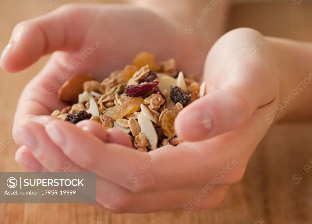 Woman holding granola in hands