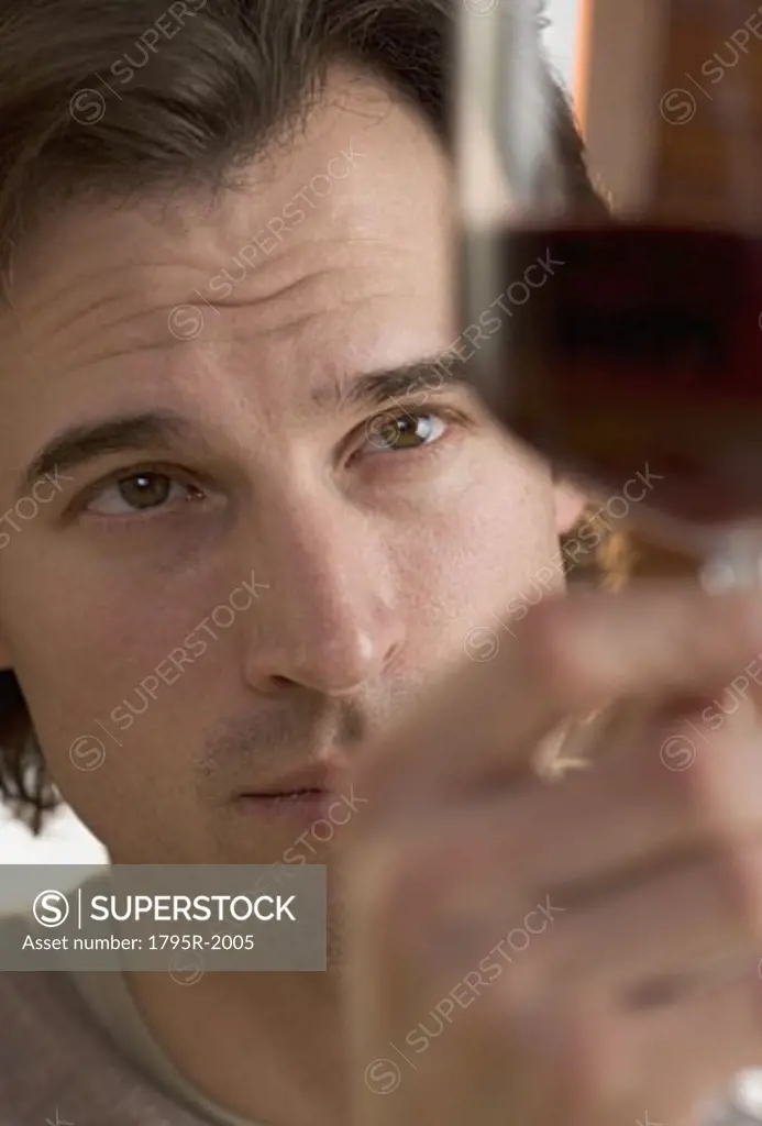Closeup of man looking at wine
