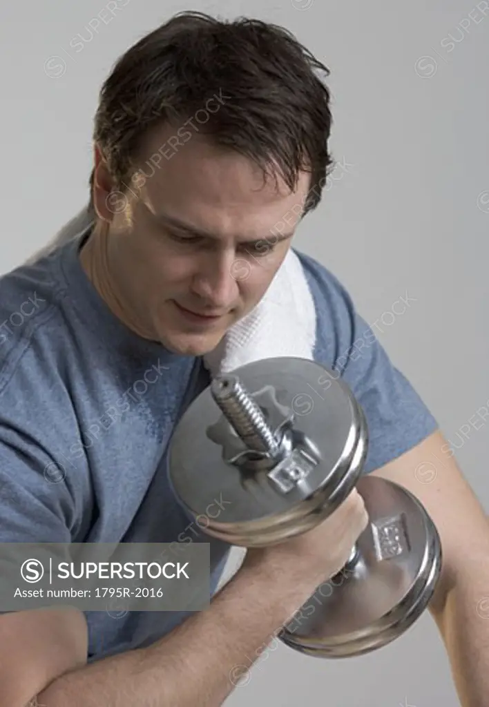 Sweating man lifting weights