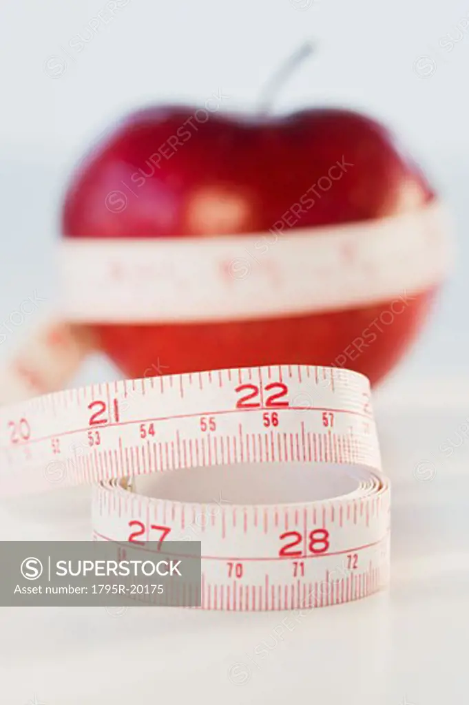 Apple wrapped in tape measure