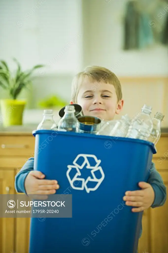 Boy carrying full recycling bin