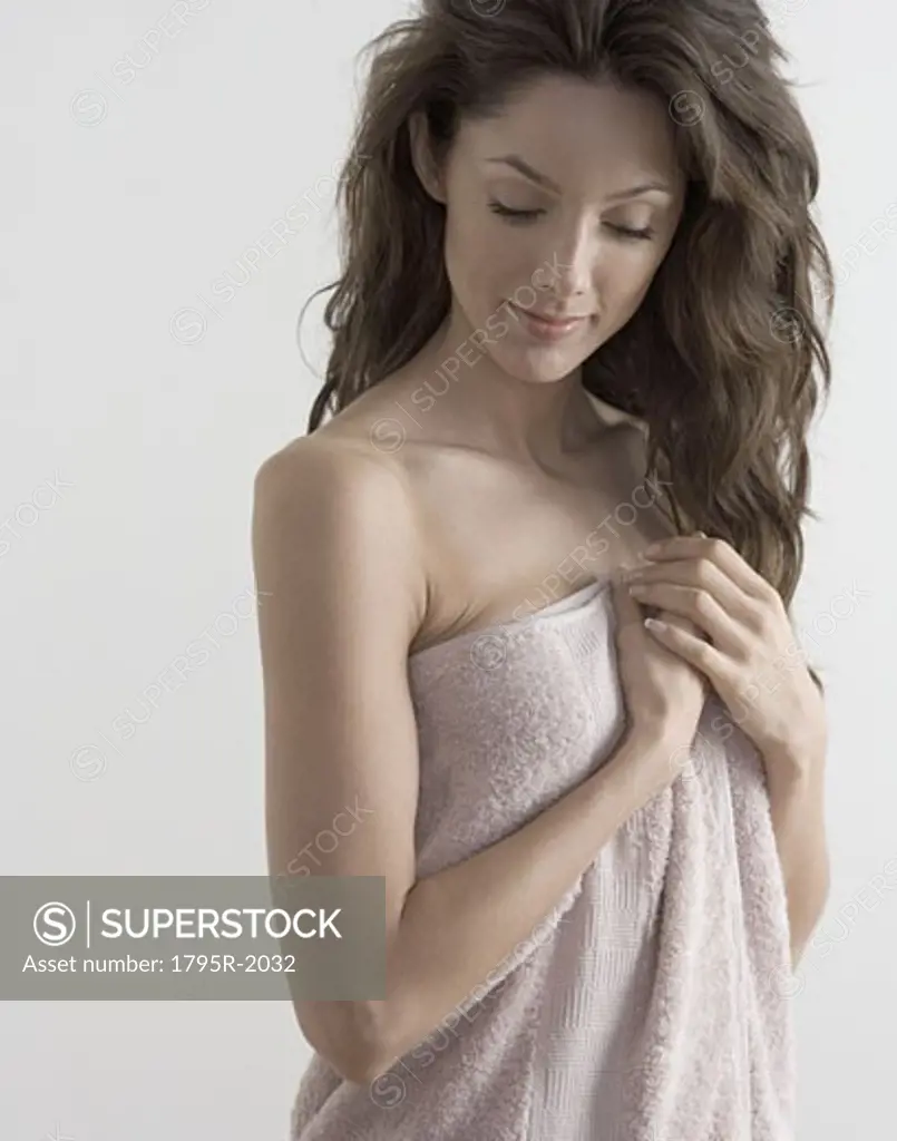 Woman in towel smiling gently