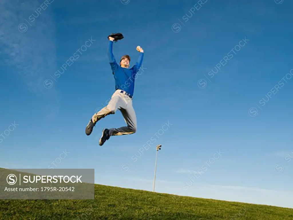 Baseball player jumping in air