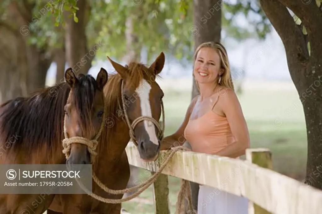 Woman posing with horses