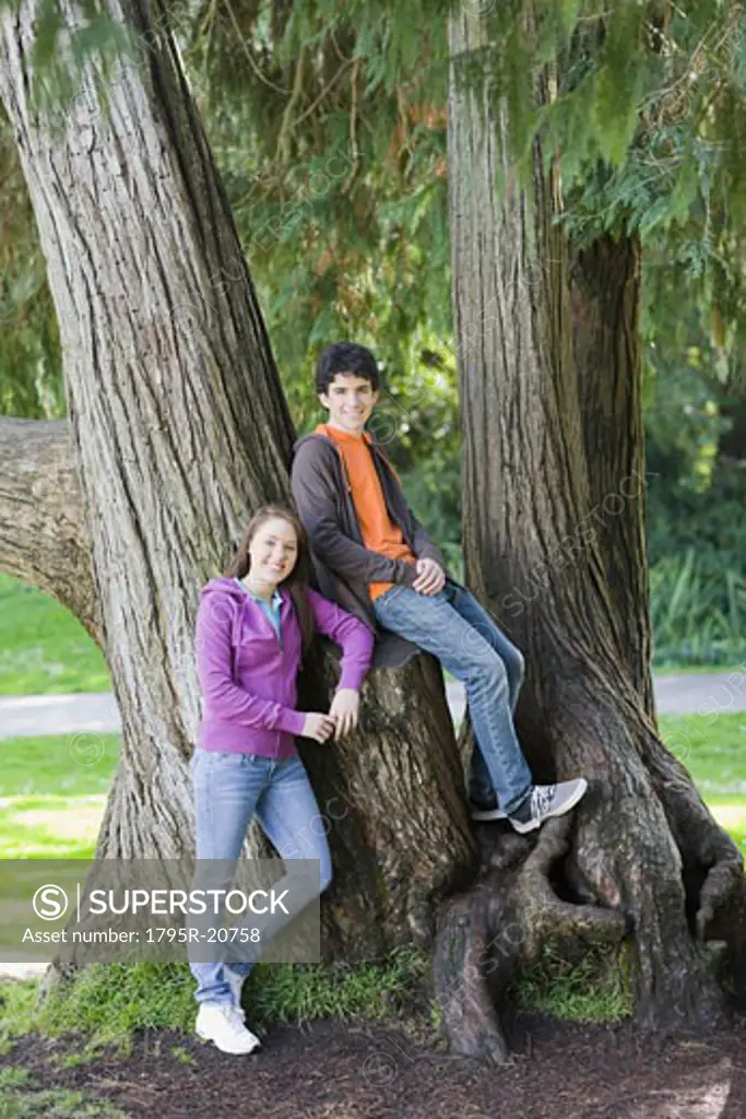Friends posing in tree in park