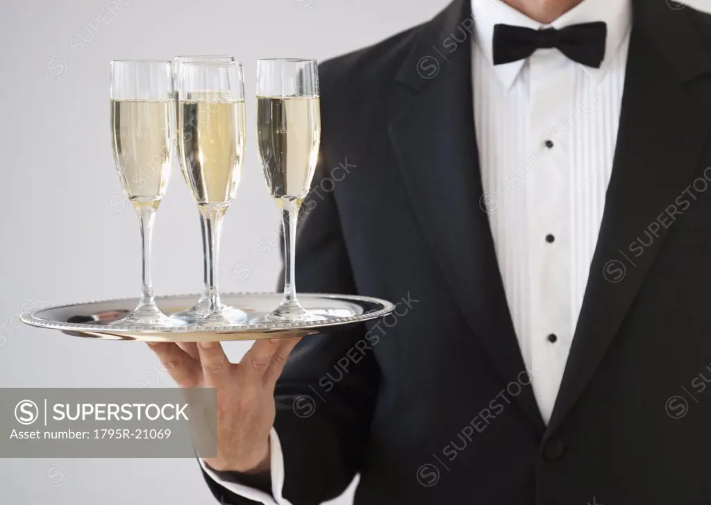 Champagne being served on a silver tray