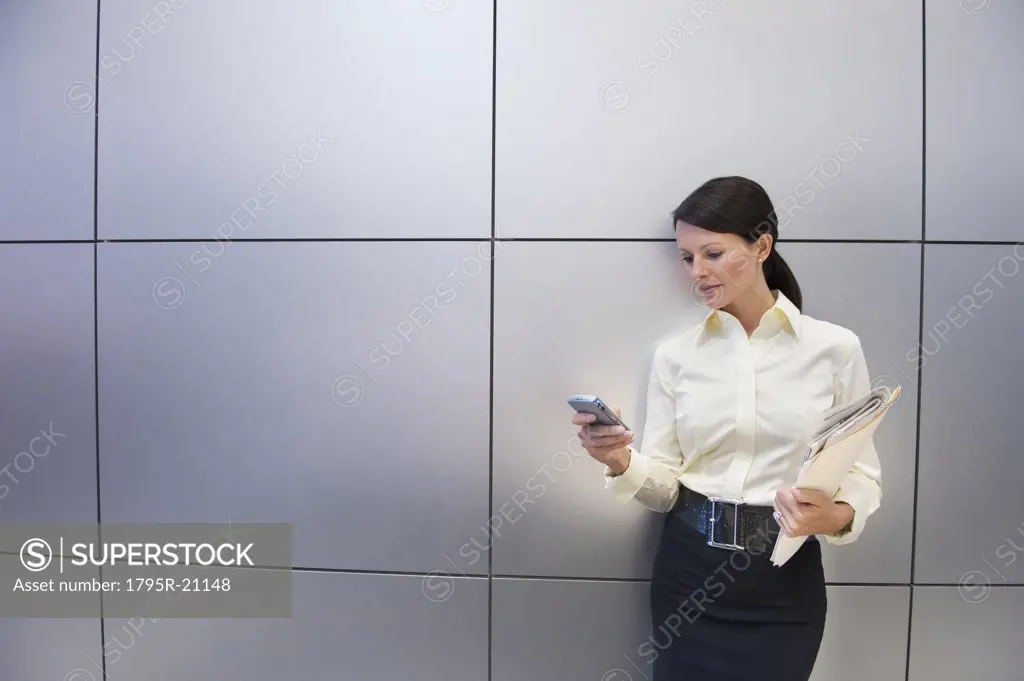 A businesswoman using a personal digital assistant