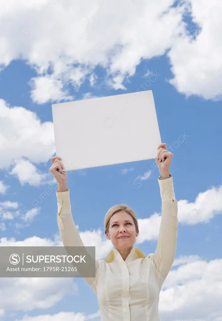 Woman holding a blank sign