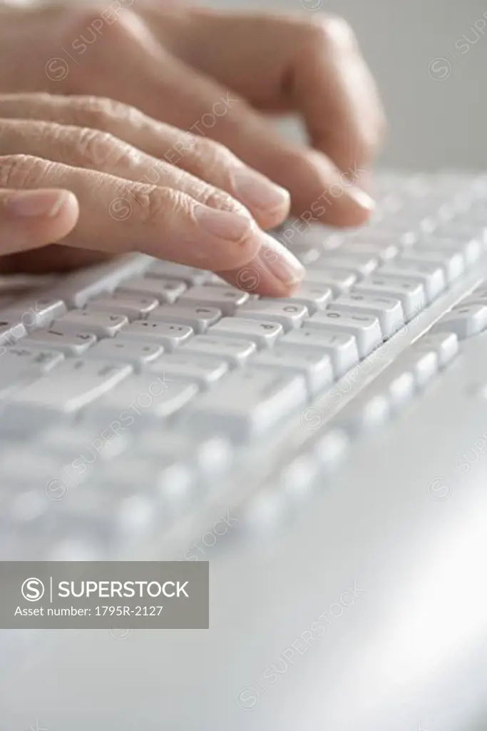 Closeup of hands typing on keyboard