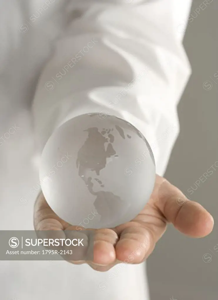 Glass globe held in outstretched hand