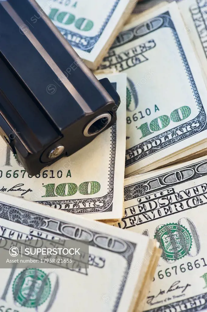 A handgun on stacks of money
