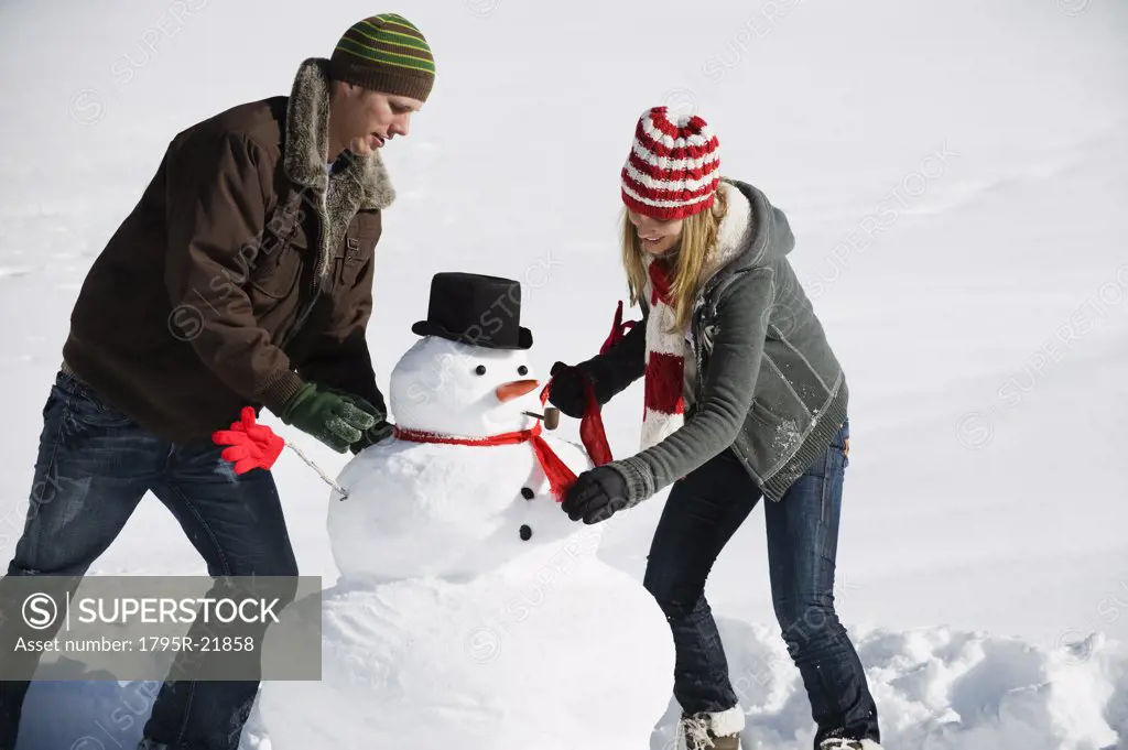 A couple making a snowman