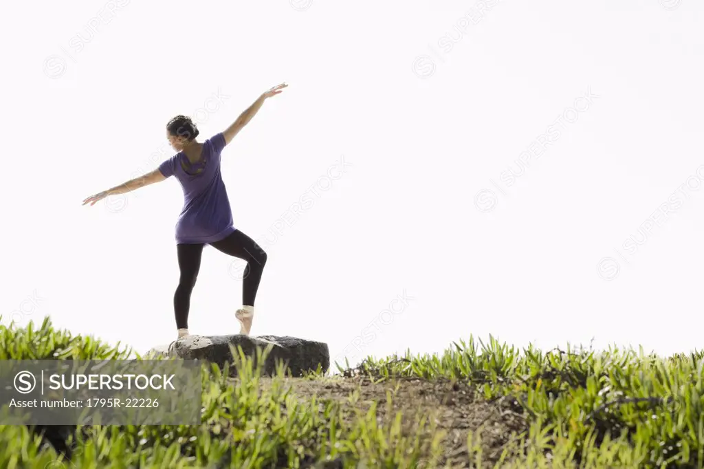 A woman dancing outdoors