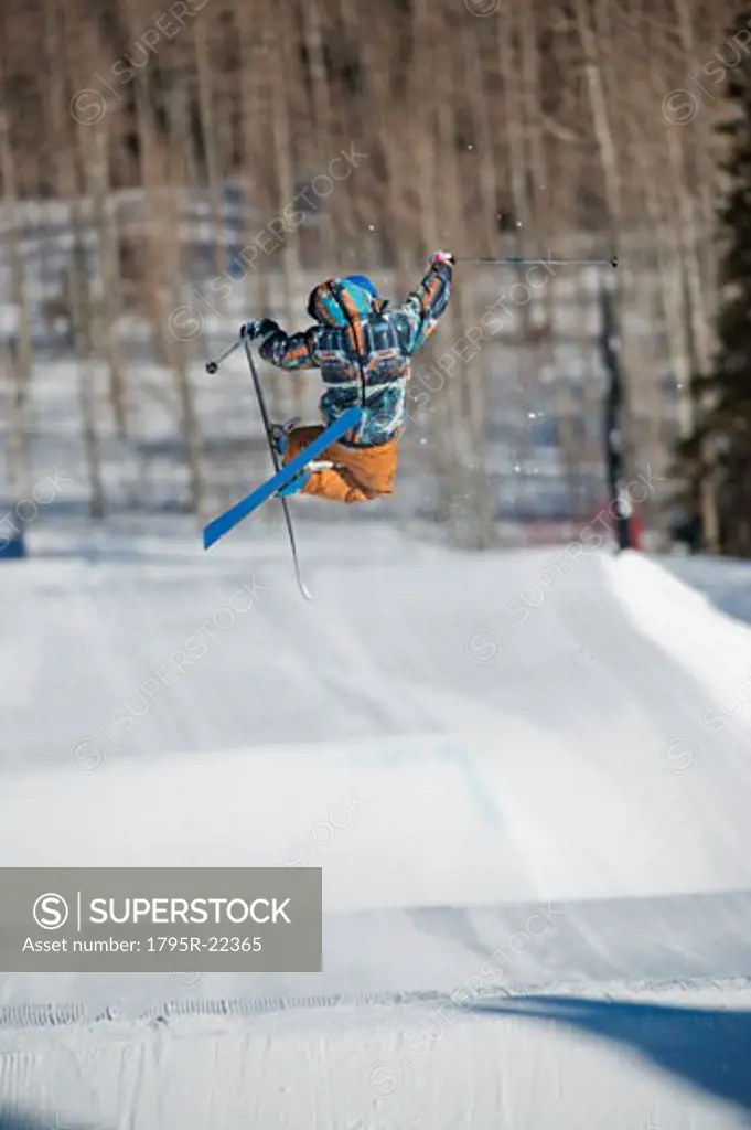 A downhill skier jumping