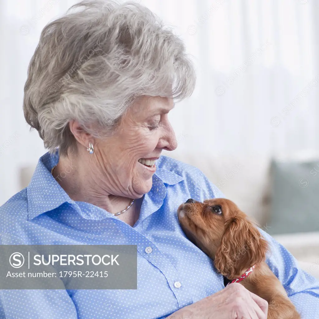 Senior woman hugging puppy
