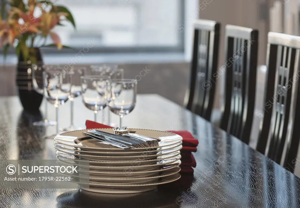 Stack of plates on table in dining room
