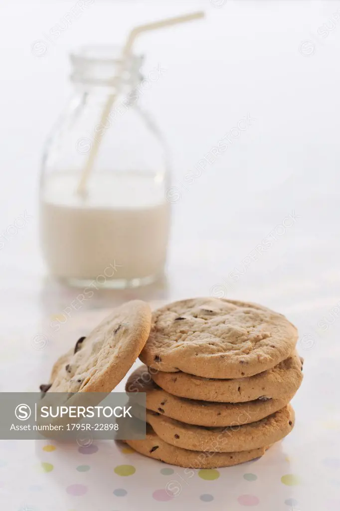 Stack of cookies with milk on table