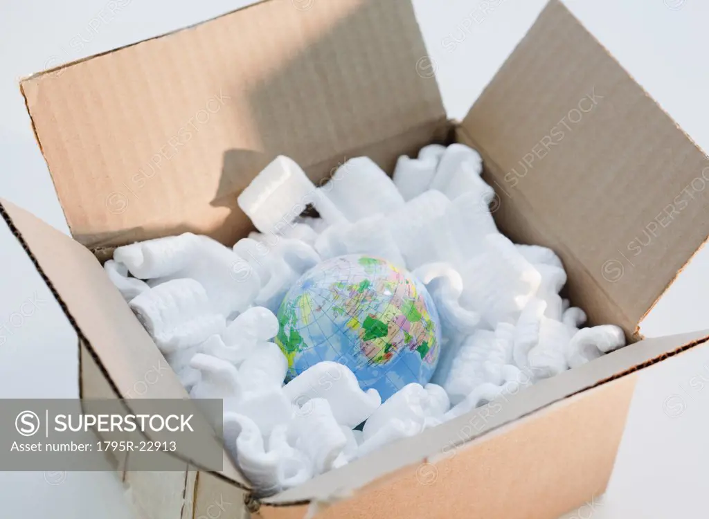 Globe in cardboard box with packing peanuts