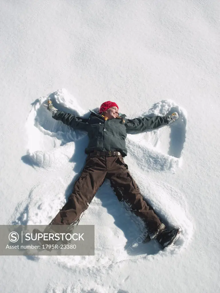 Woman making snow angel