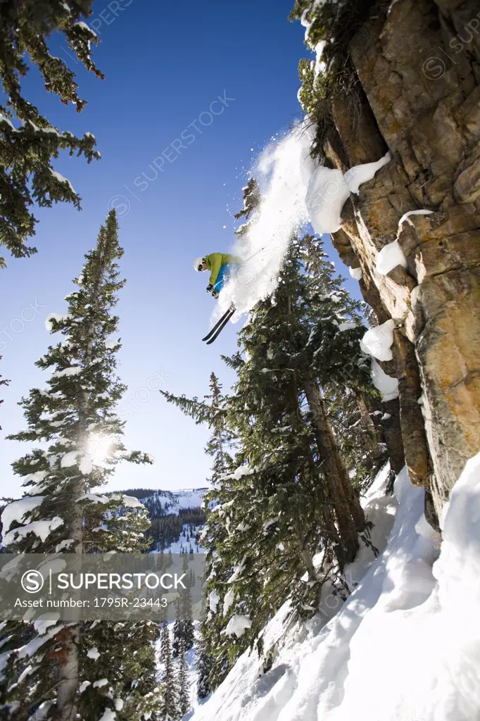 Skier jumping off cliff Aspen Snowmass, Aspen, Colorado, USA