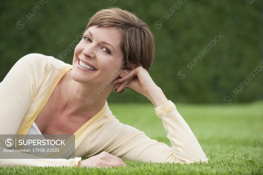 Woman lying on grass smiling