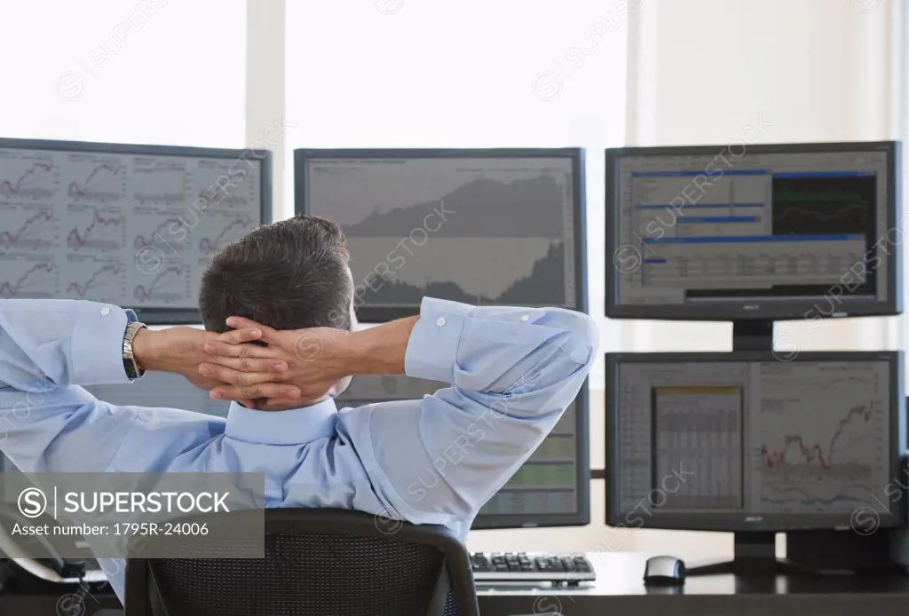 Relaxed male trader at work