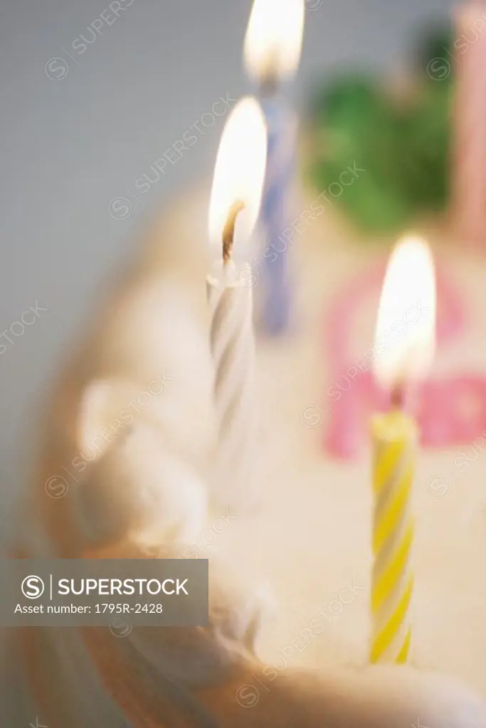 Lit candles on a birthday cake