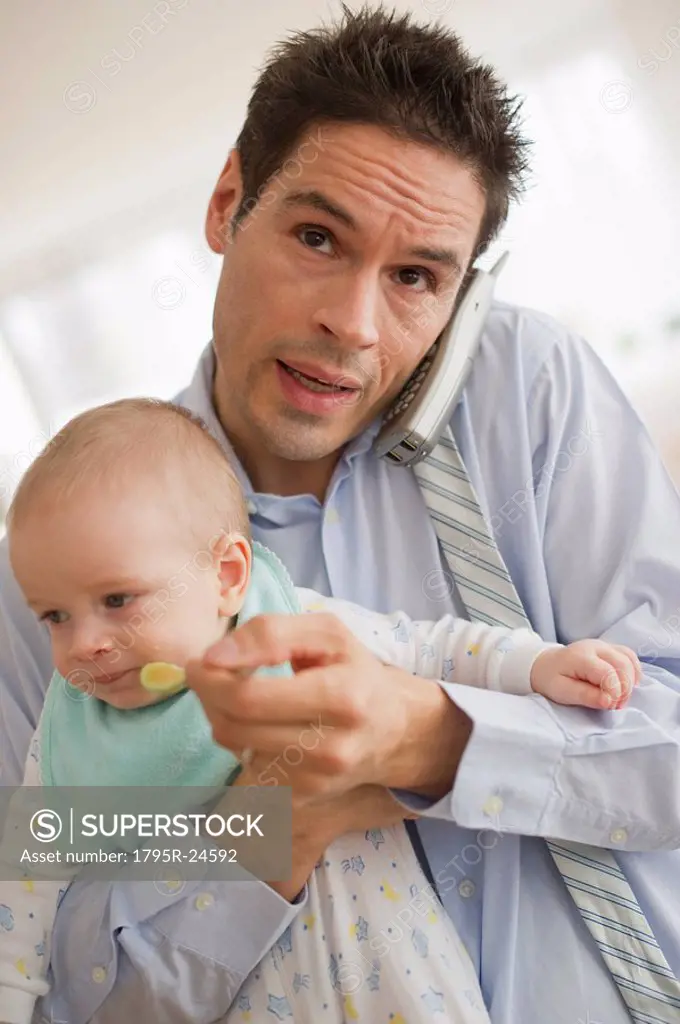 Businessman holding baby