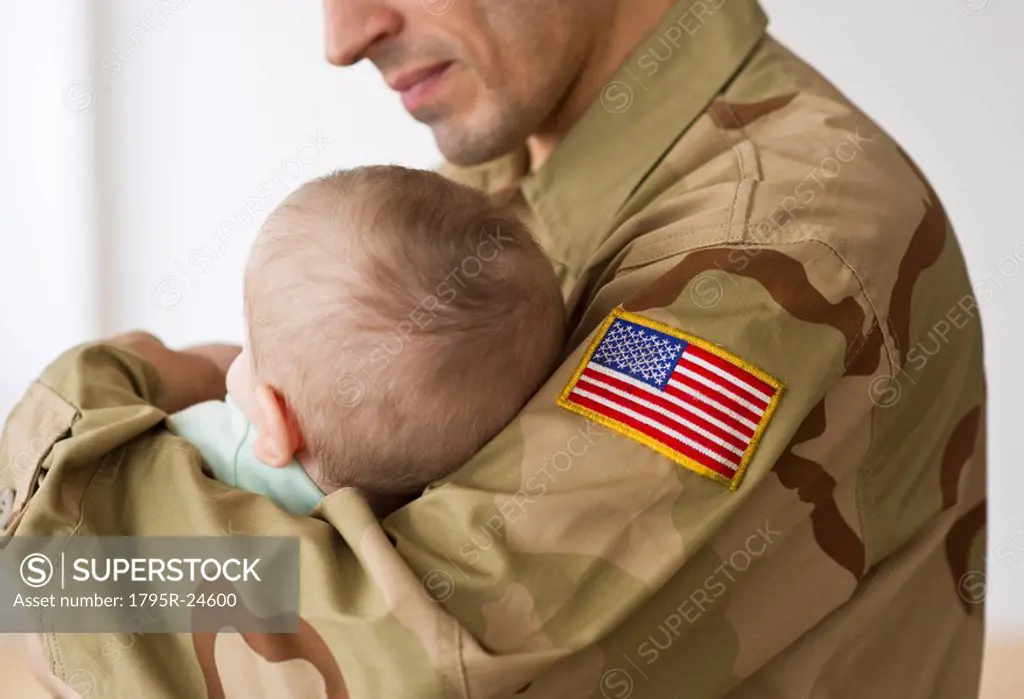 Soldier holding baby