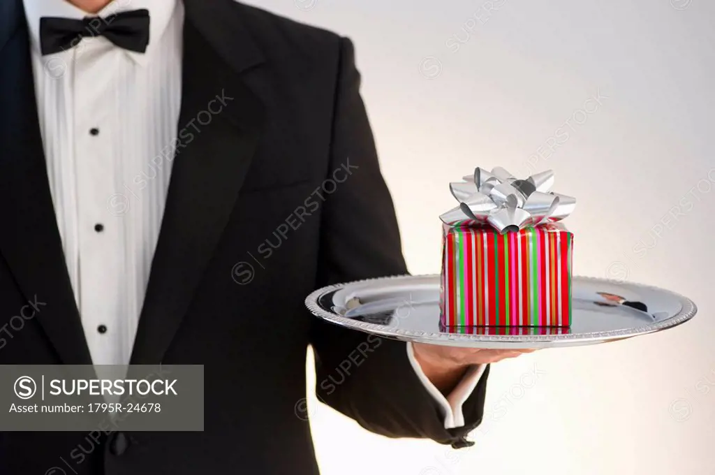 Butler holding gift