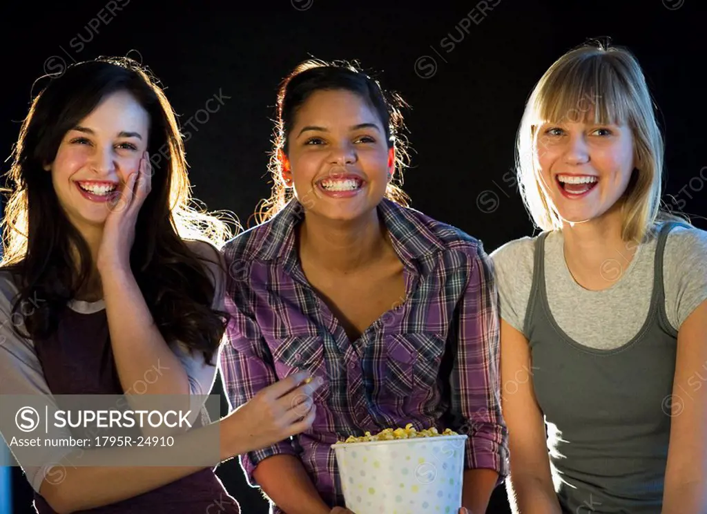 Young girls eating popcorn