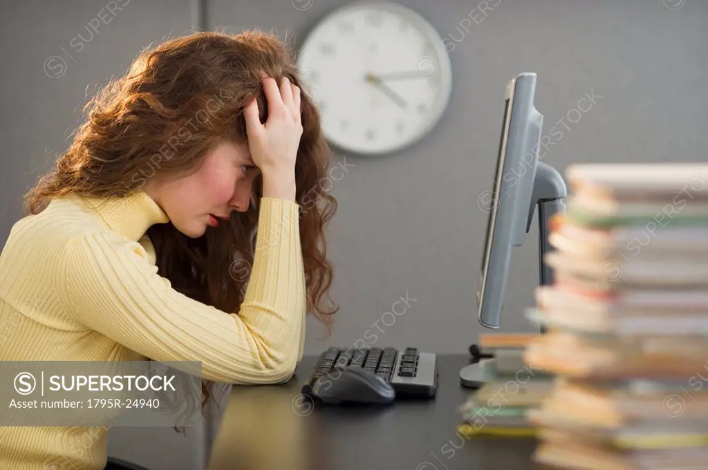 Overworked woman in cubicle