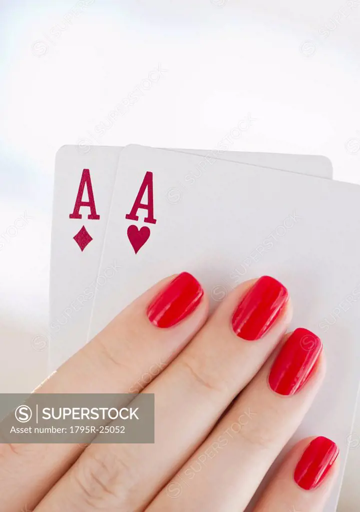 Hand holding a pair of aces