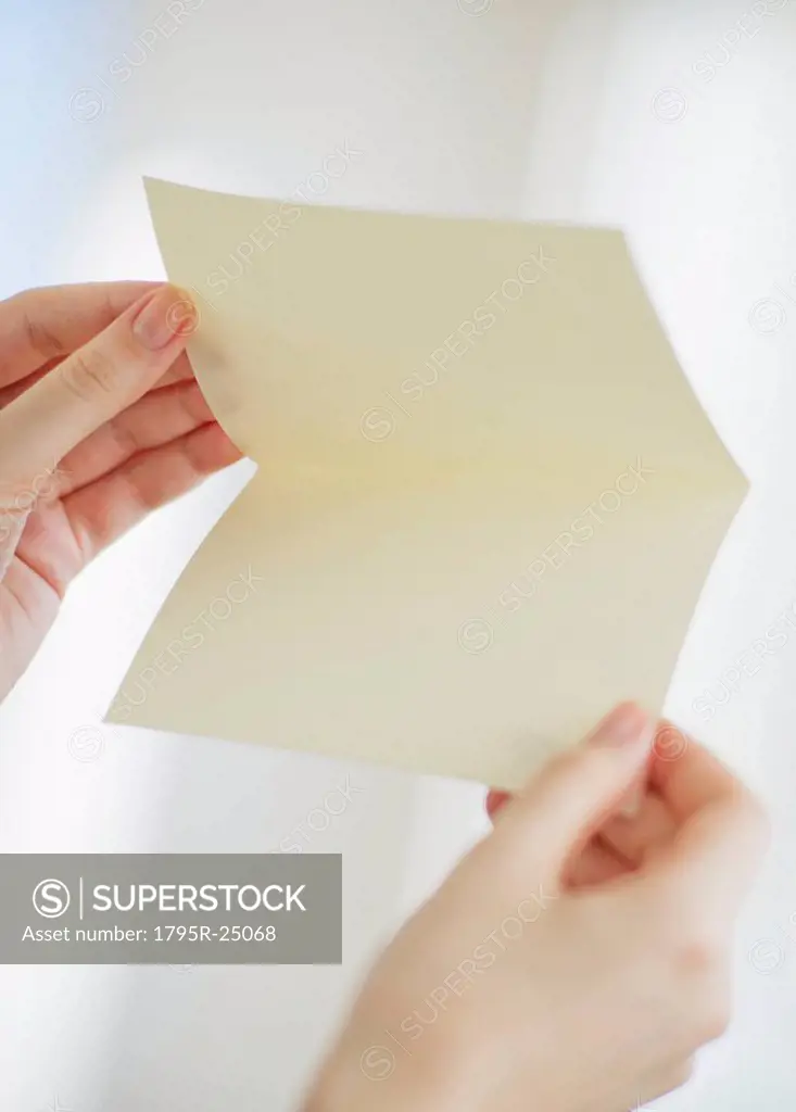 Hands opening a blank card