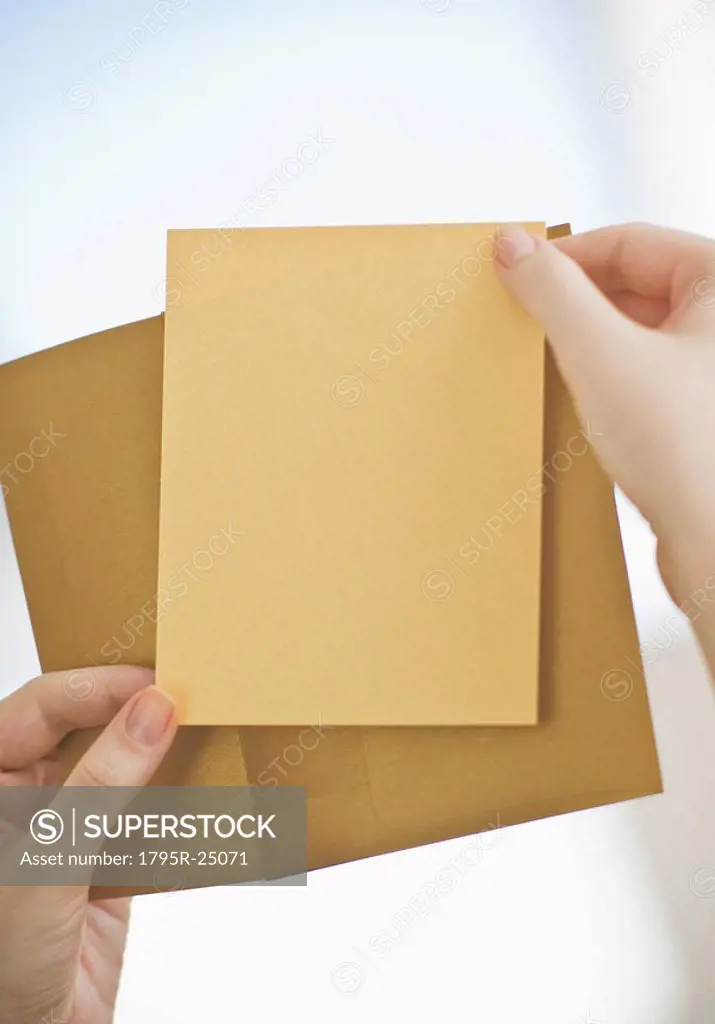 Hands holding a blank card