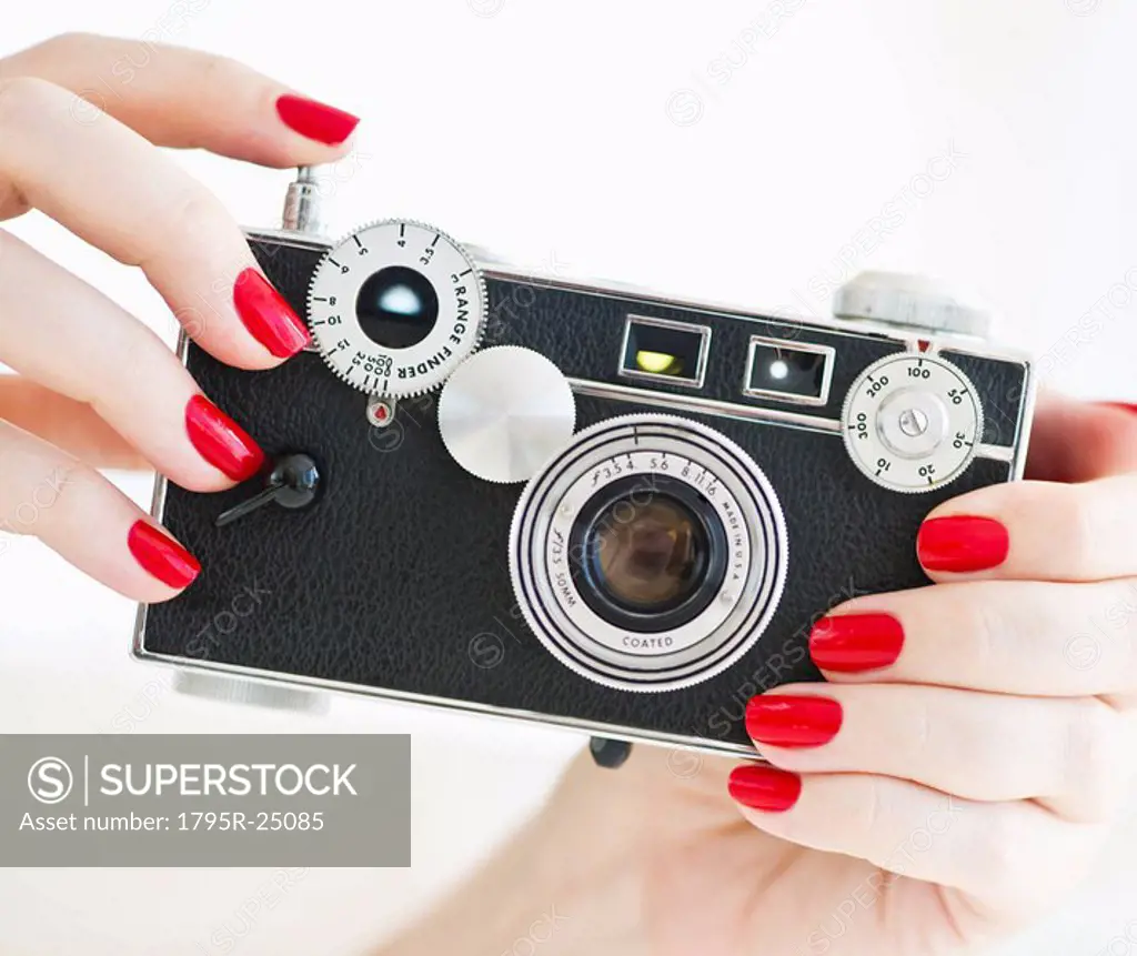 Woman holding antique camera