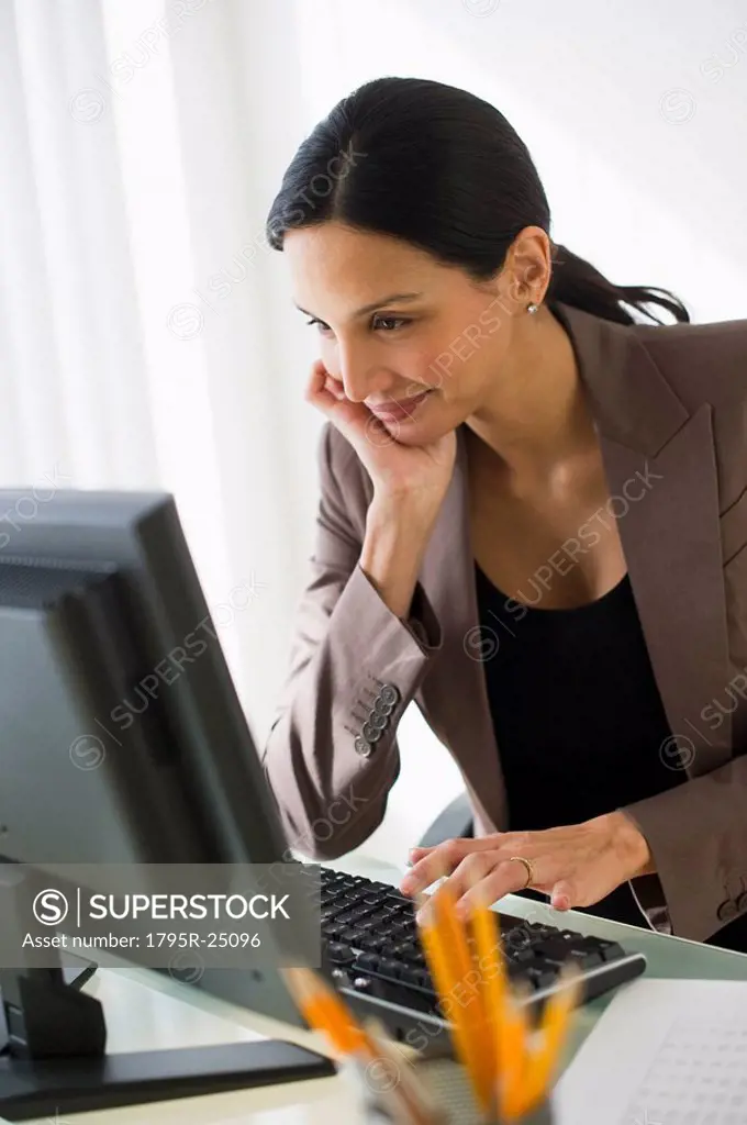 Pregnant businesswoman working on computer