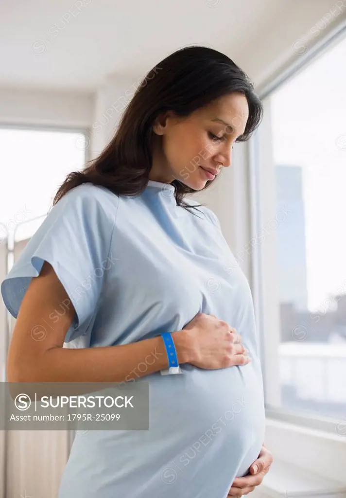 Pregnant woman wearing hospital gown