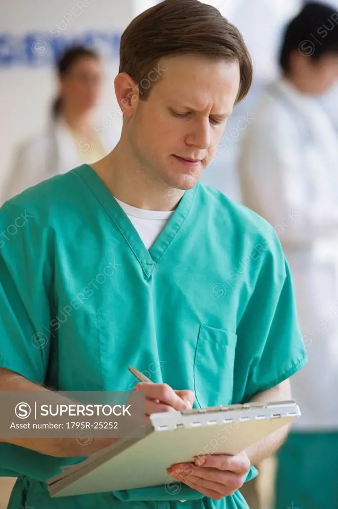 Doctor writing on chart