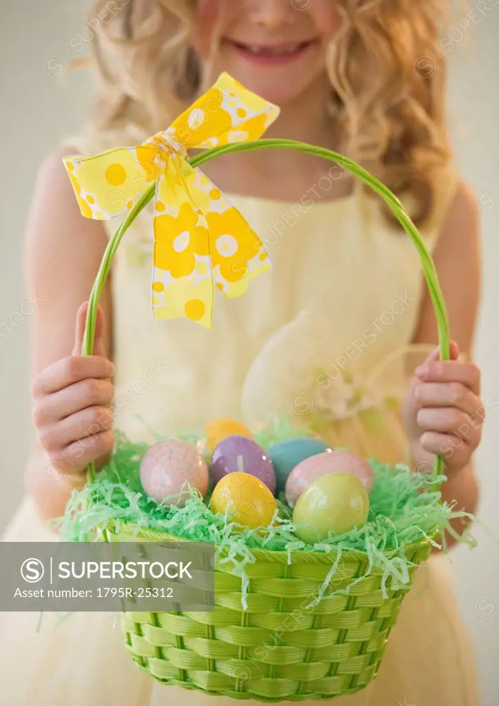 Young girl holding a basket of Easter eggs