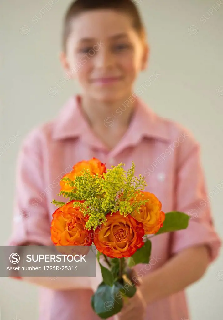 Young boy holding a bouquet of roses